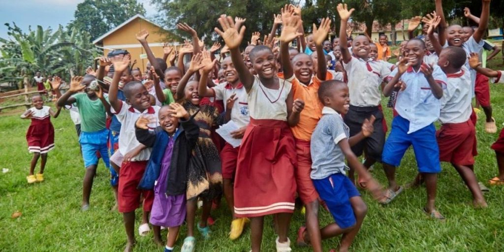 Pupils celebrating outside their classroom at a school supported by the Foundation
